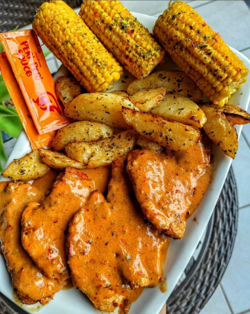 Nandos chicken served with wedges and spiced corn