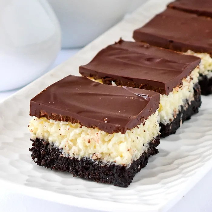 Close up photo of Coconut Bounty Cookie Bars on a white platter