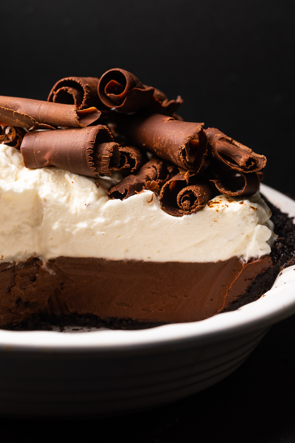 This over-the-top Espresso Chocolate Pudding Pie is a chocolate lovers dream come true! Featuring a chocolate cookie crust, silky smooth espresso chocolate pudding, and a luscious layer of freshly whipped cream, this recipe is always a crowd-pleaser! Top with chocolate curls for a show stopping presentation!